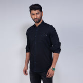 Man wearing a black shirt against a white background