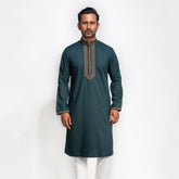 Man wearing a dark green kurta with white pants on a white background