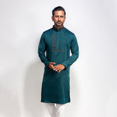 Man wearing a green panjabi with white pants on a white background