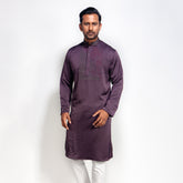 Man wearing a purple panjabi with white pants on a white background