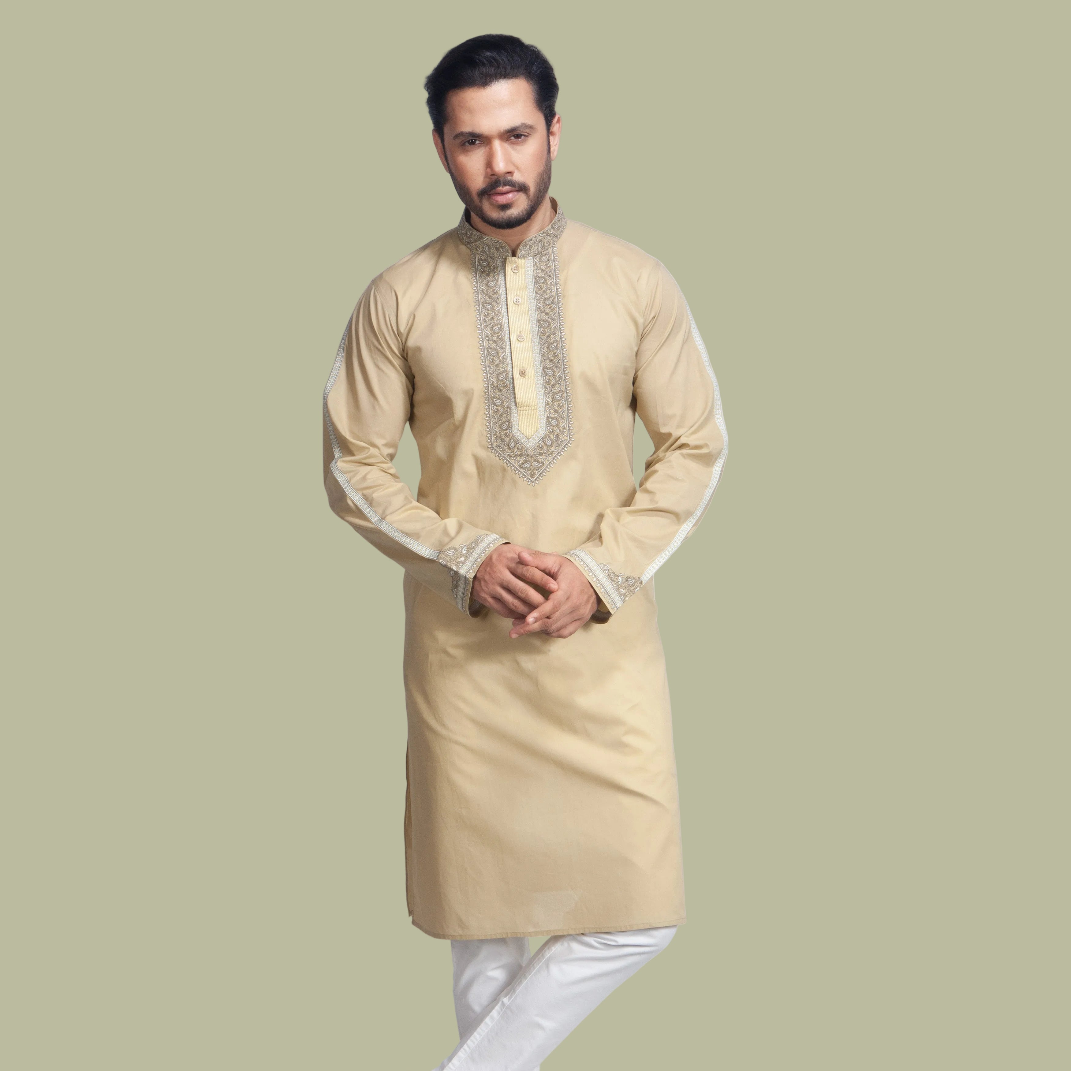 Man wearing a beige kurta with white pants on a light gray background