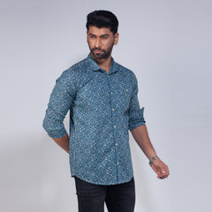 Man wearing a blue patterned shirt against a white background