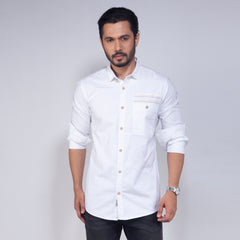 Man wearing a white button-up shirt against a plain background