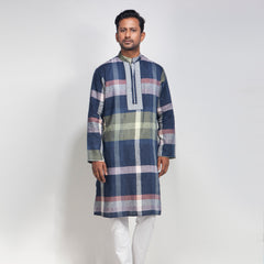 Man wearing a plaid panjabi with white pants on a light gray background