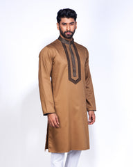 A man modeling a traditional Bone Brown long-sleeve kurta with dark brown embroidered trim on the chest and collar, paired with white trousers, against a plain white studio background.