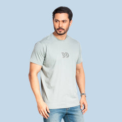 Man wearing a natural t-shirt with a logo on a white background