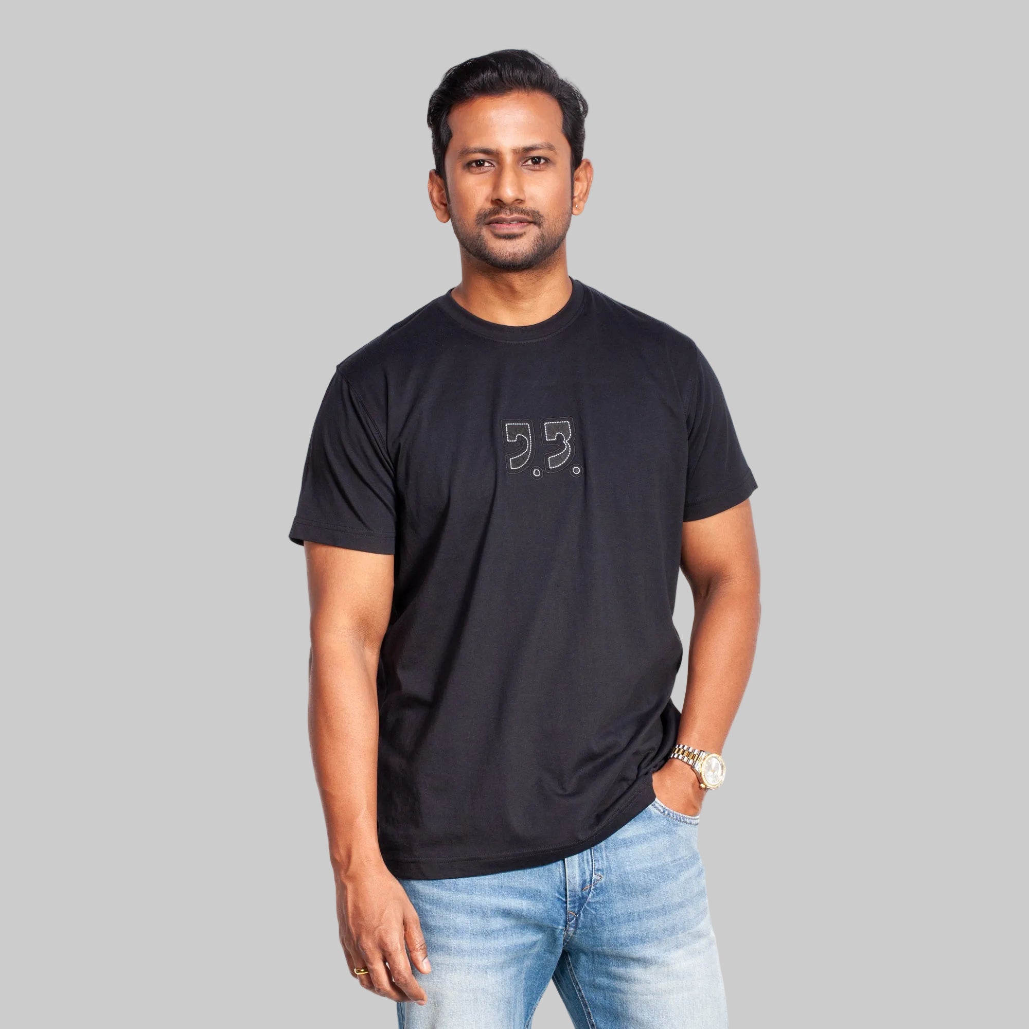 Man wearing a black t-shirt with a logo on a white background