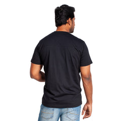 Man wearing a black t-shirt and blue jeans on a white background