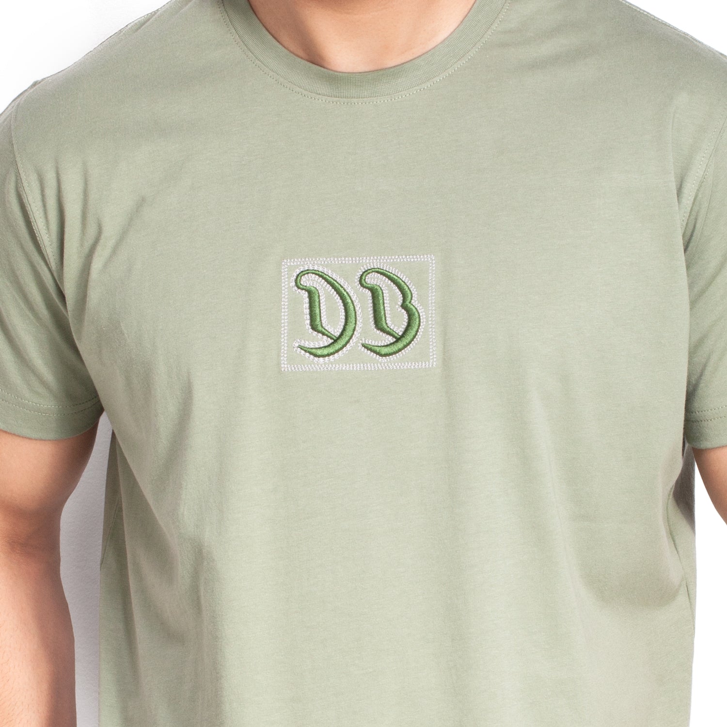 Green t-shirt with a logo on a white background