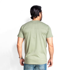 Man wearing a olive t-shirt on a white background
