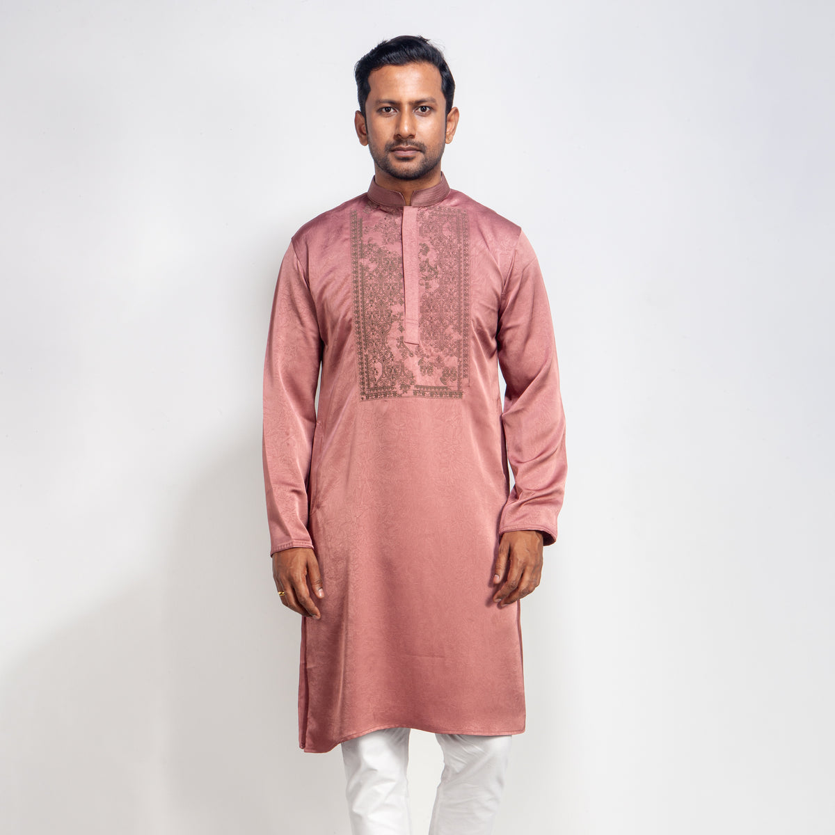 Man wearing a DUSTY ROSE kurta with white pants on a light gray background