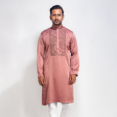 Man wearing a DUSTY ROSE kurta with white pants on a light gray background