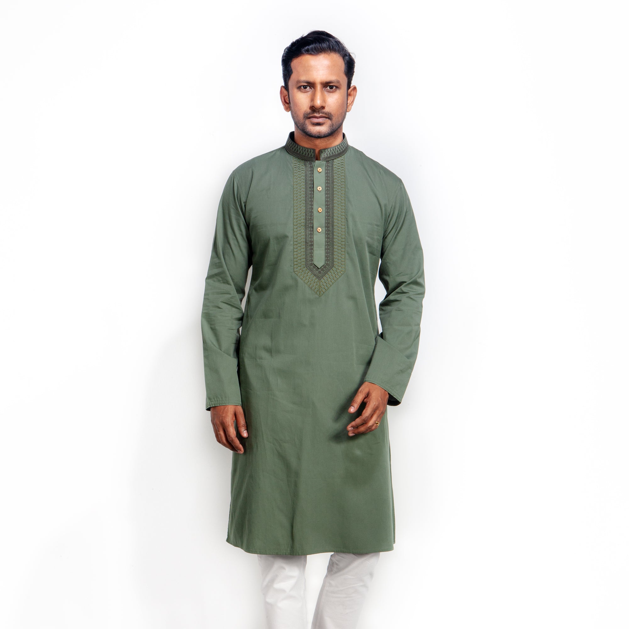 Man wearing a green kurta with white pants on a white background