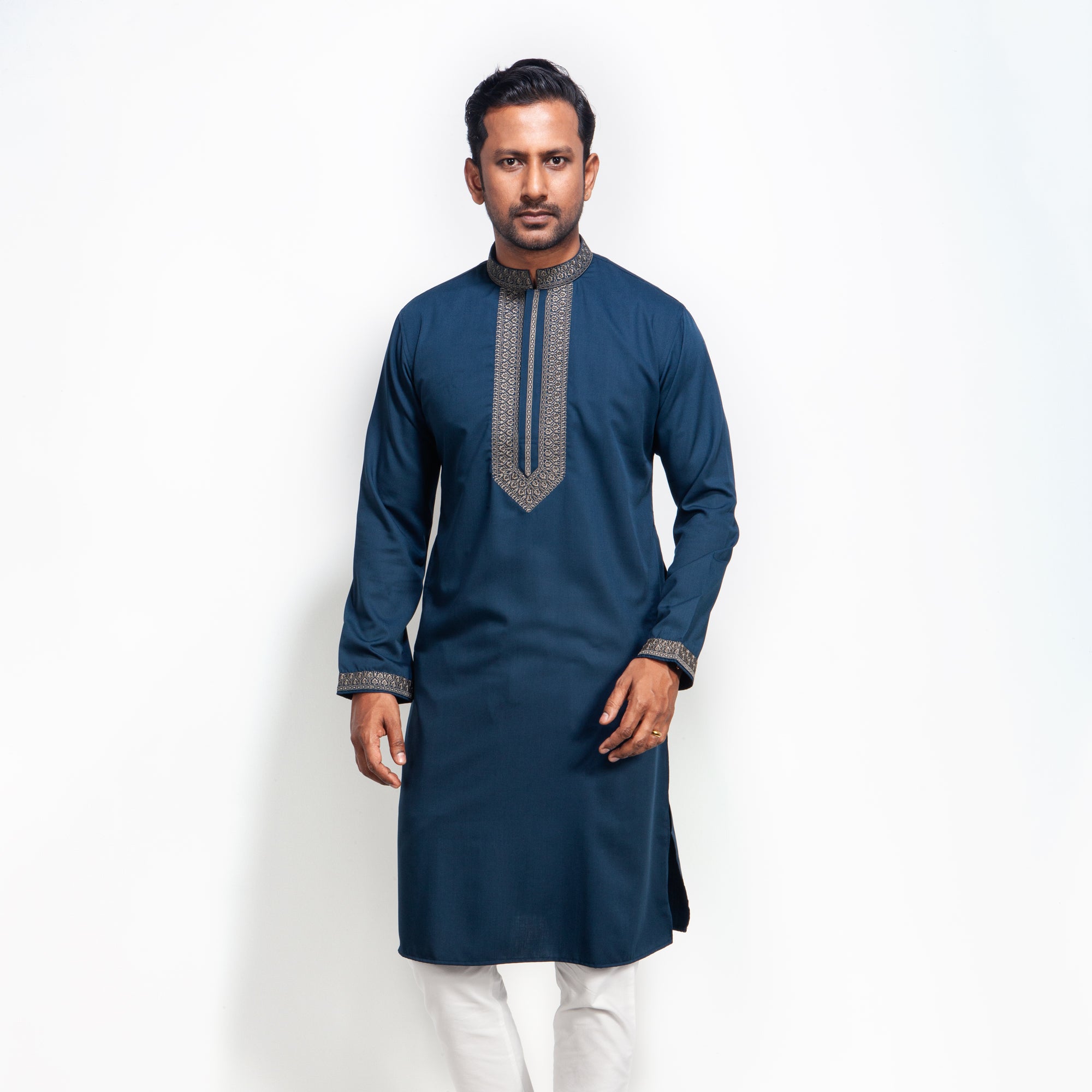 Man wearing a blue panjabi with white pants on a white background