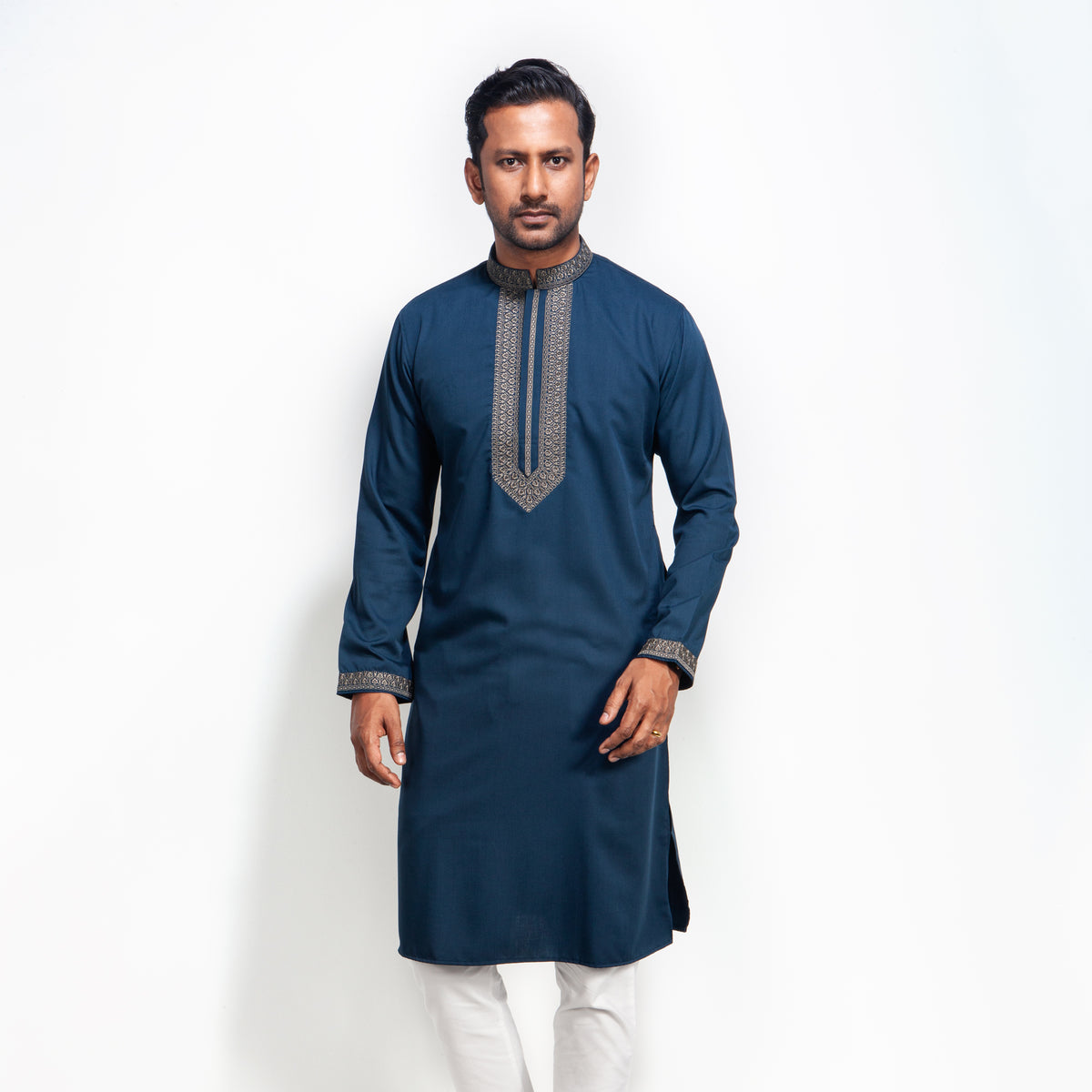 Man wearing a blue panjabi with white pants on a white background