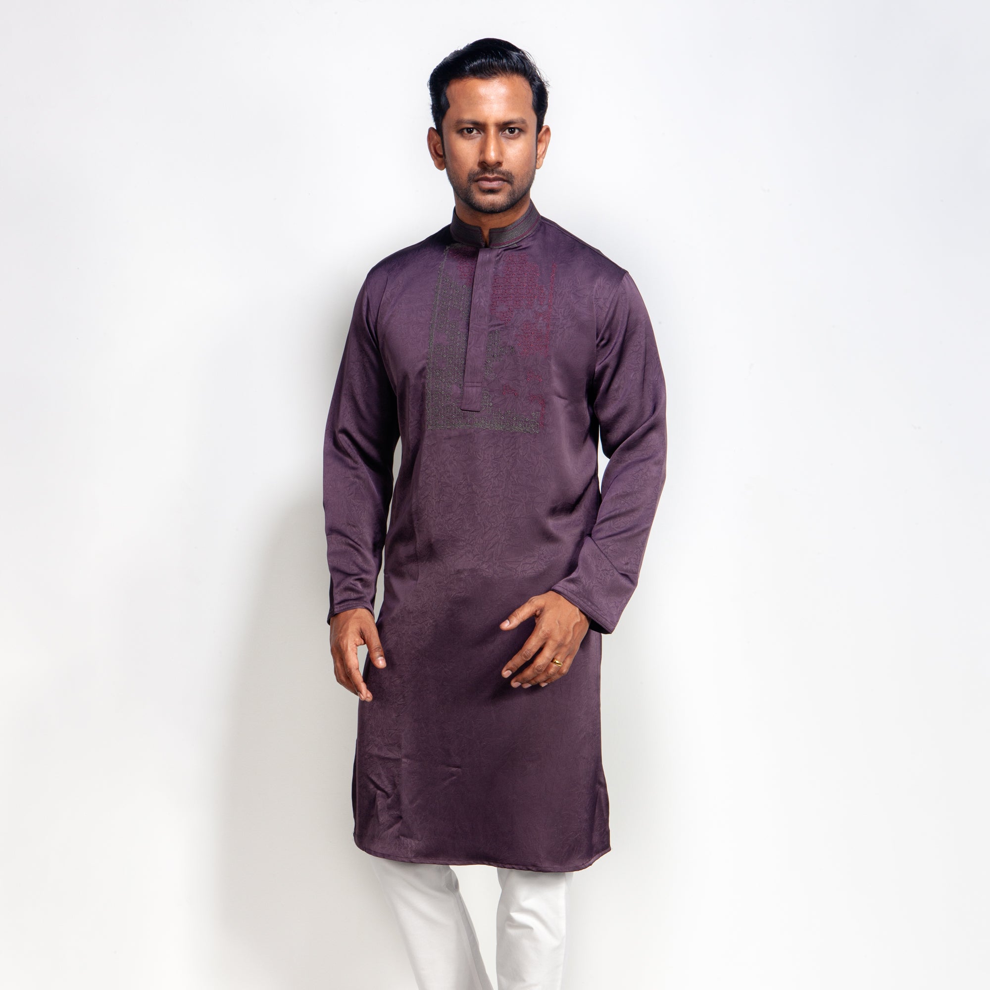 Man wearing a purple panjabi with white pants on a white background