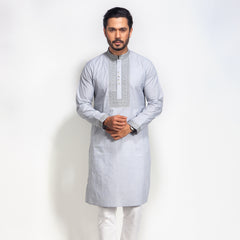 Man wearing a light gray kurta with white pants on a white background