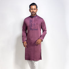 Man wearing a purple panjabi with white pants on a light gray background