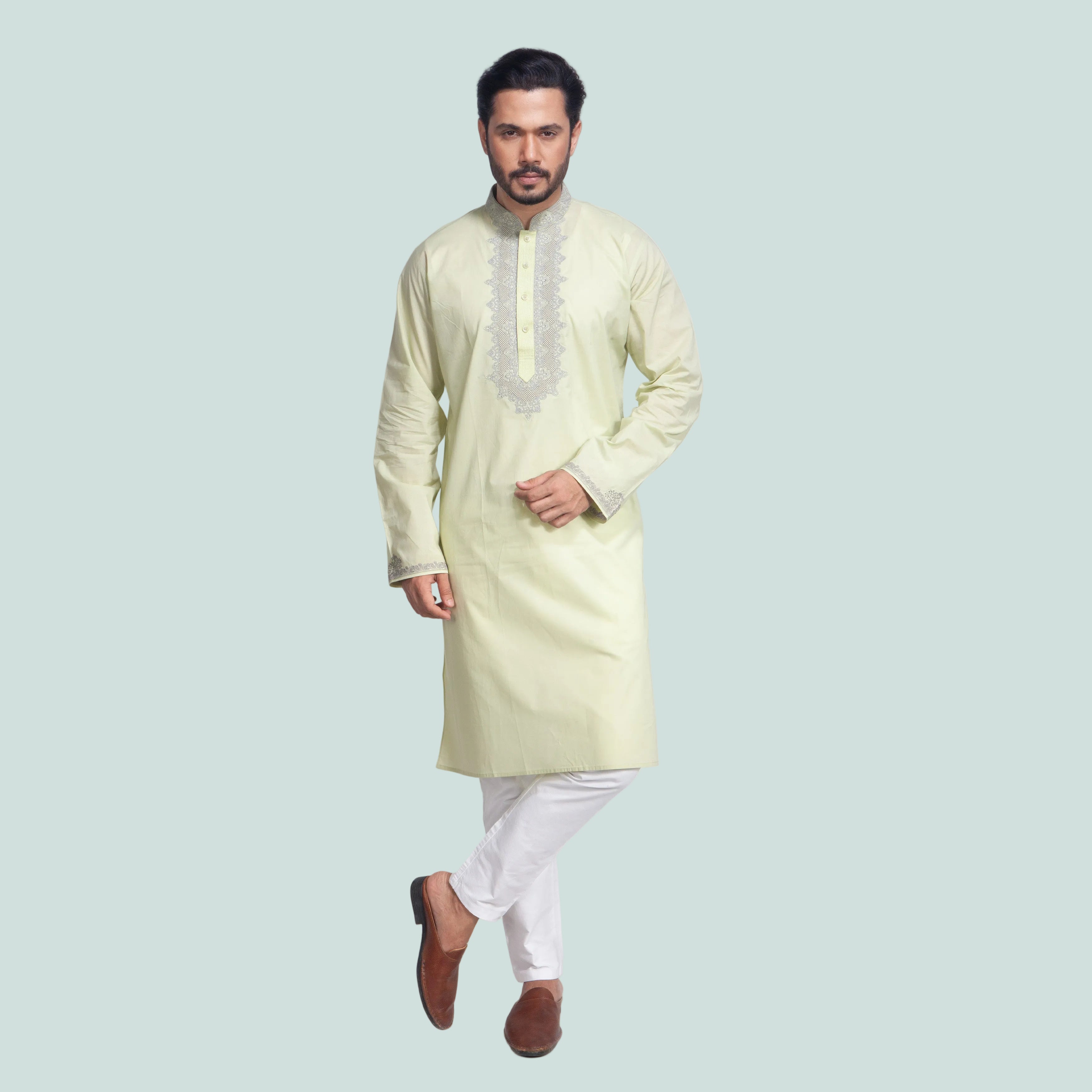 Man wearing a light green kurta with white pants on a white background