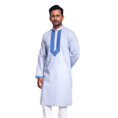 Man wearing a light blue panjabi with white pants on a white background