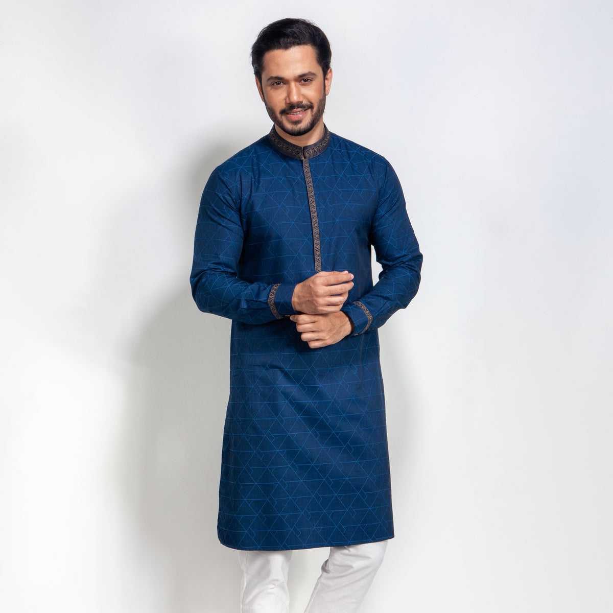 Man wearing a blue panjabi with white pants on a white background