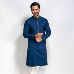 Man wearing a blue panjabi with white pants on a white background