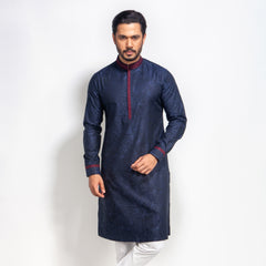 Man wearing a navy blue panjabi with red details on a white background